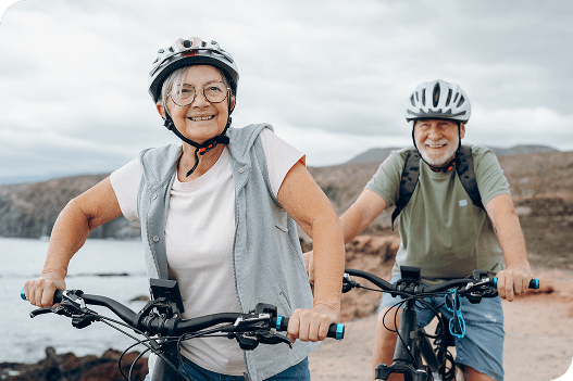 Older adults riding bikes, healthy after ROSA® surgery